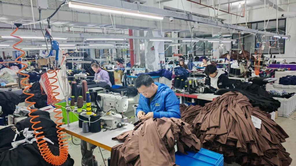 Industrial sewing lines in operation at the SLSUHAKA partner factory in Yiwu, China.