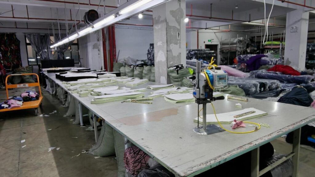 Fabric cutting table and electric cutting machine at the SLSUHAKA partner factory.