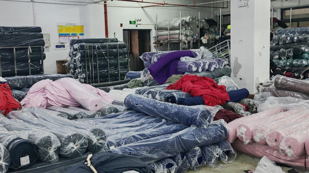 Rolls of performance fabric stored in the SLSUHAKA partner factory warehouse.