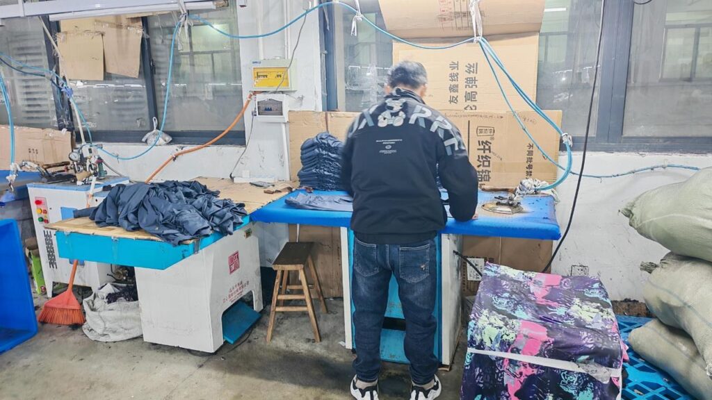 Steam ironing and finishing station before final packing.